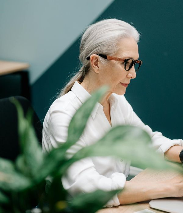 Project coordinator evaluating different implementation approaches on computer