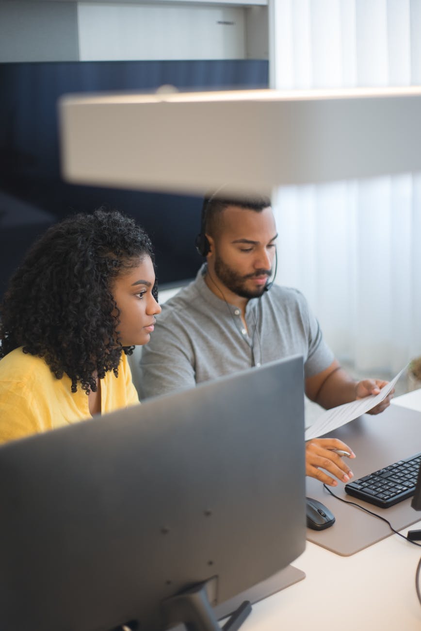 Project coordinator evaluating different implementation approaches on computer